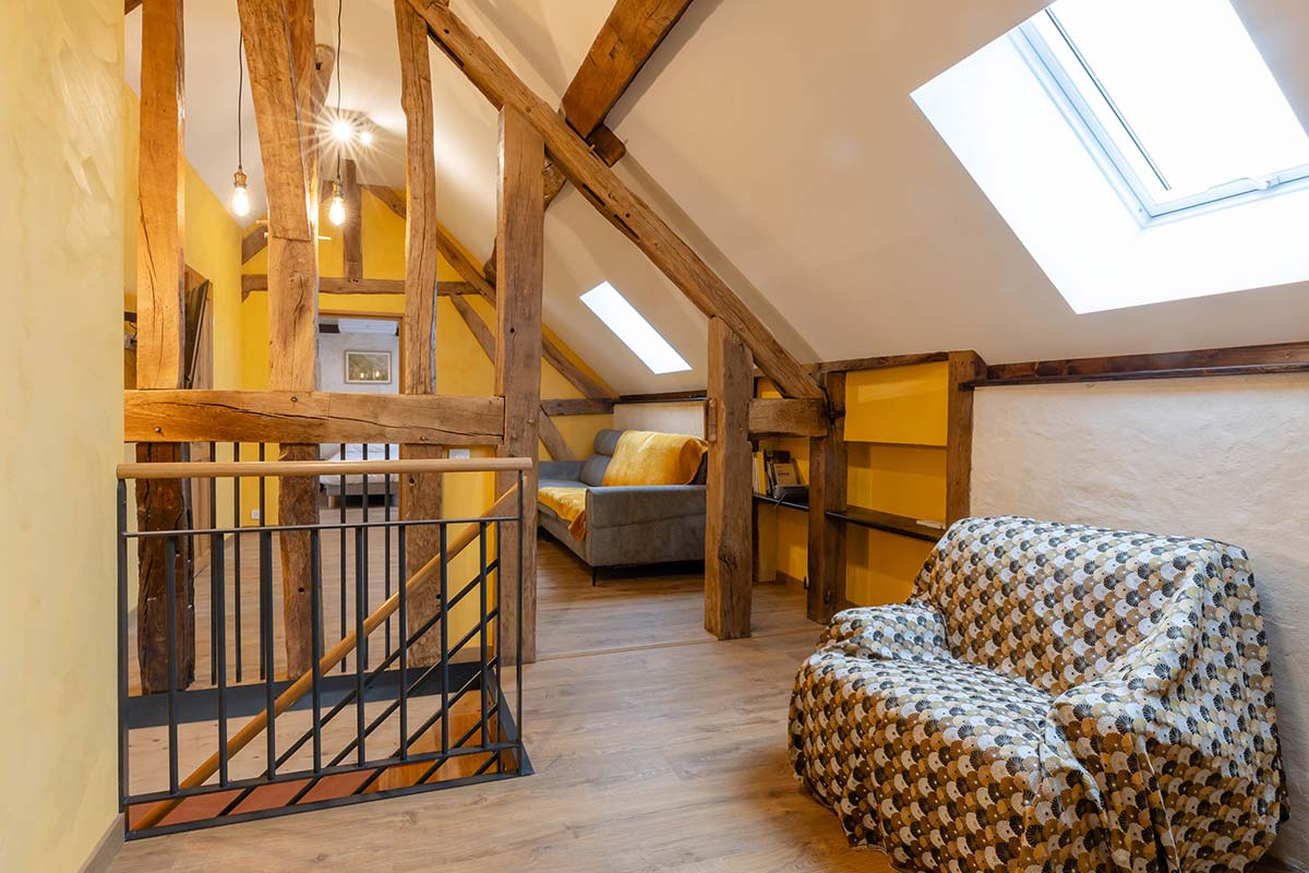 Bedroom in L'Hirondelle gîte — clay renders and natural materials