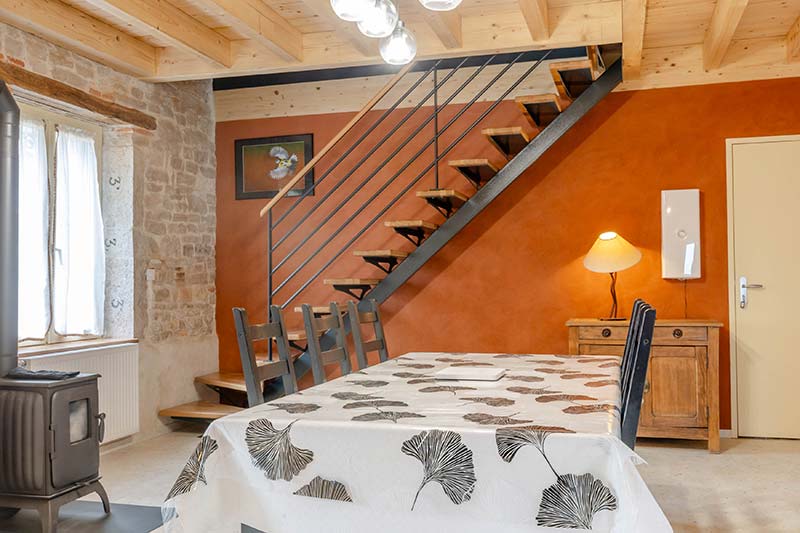 Dining room of L'Hirondelle gîte — stone and wood, family gîte near Beaune
